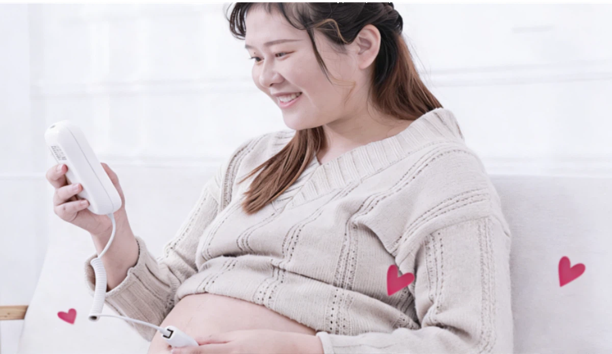 Pregnant moms use a fetal doppler at home to listen to their baby's heartbeat Pregnant moms use a fetal doppler at home to listen to their baby's heartbeat